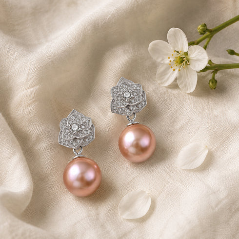 Pair of earrings with silver floral diamond-studded tops and peach freshwater pearl drops