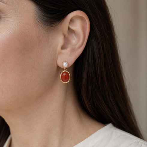 Earrings: House Of Pearls - LXP red oval gemstone drop with white pearl stud in gold setting.