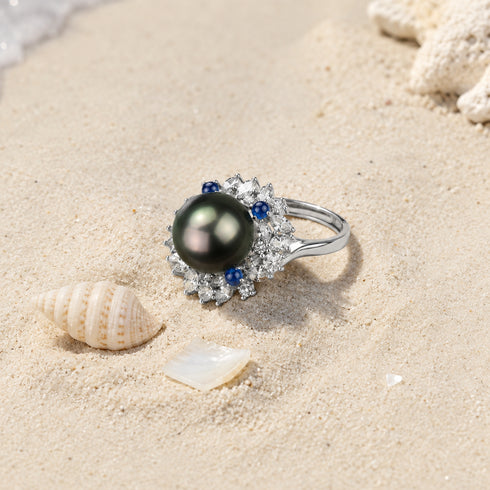 Ring, 11–12mm Tahitian pearl halo with diamond surround and blue sapphire accents on a silver band.