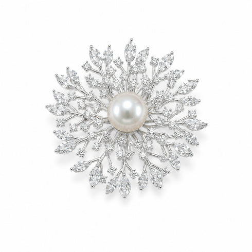 Brooch: Snowflake design with a 10–11mm freshwater pearl center and clear crystal accents on silver-tone metal.