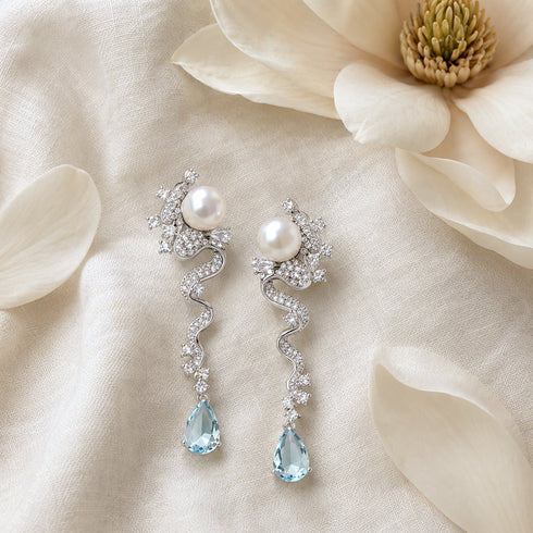 Pair of freshwater pearl and blue topaz earrings by House Of Pearls -TA with crystal-studded, wavy silver drops