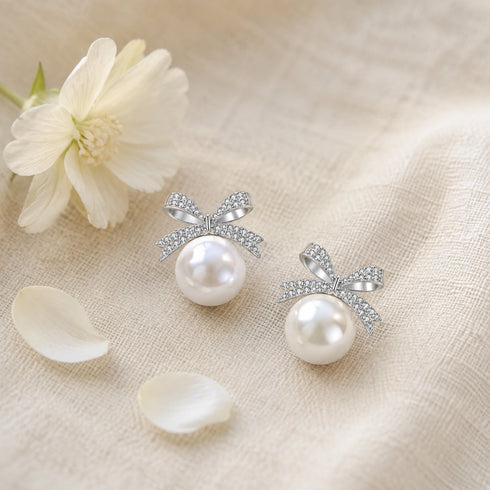 Pair of bowknot earrings with 10–11mm freshwater pearl drops and pavé CZ accents