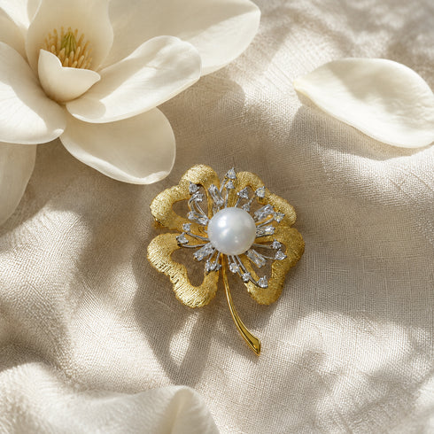 Brooch 10–11mm freshwater pearl center with gold-tone four-leaf petals and crystal accents