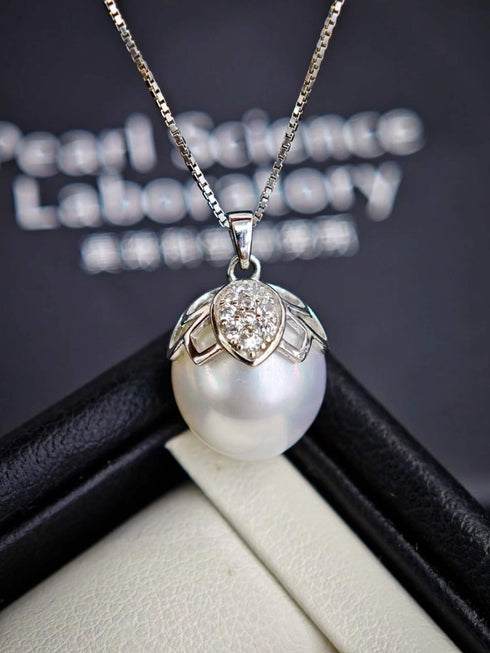 Necklace: White South Sea baroque pearl pendant with diamond-accented butterfly cap on a silver chain