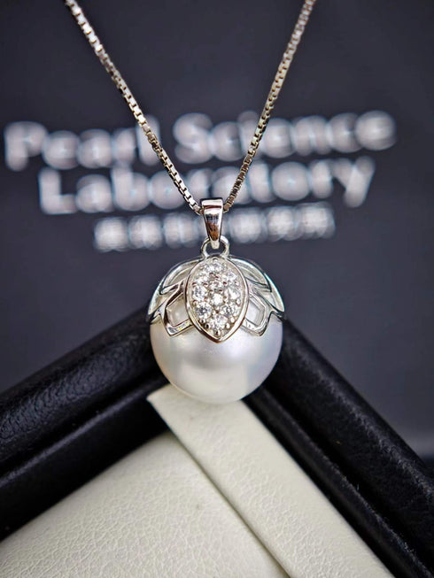 Necklace featuring a white South Sea baroque pearl with a crystal-studded butterfly pendant on a gold-tone chain.