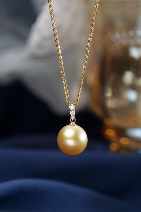 12-13mm Golden South Sea pearl pendant necklace with triple diamond accents on a gold chain, GUILD certified.