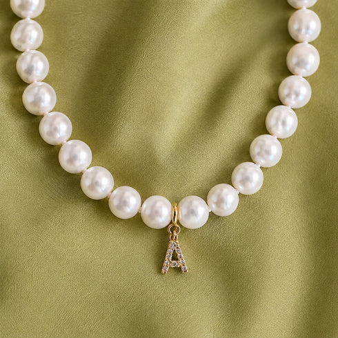 Classic white freshwater pearl necklace with a gold A charm pendant; available in multiple lengths.