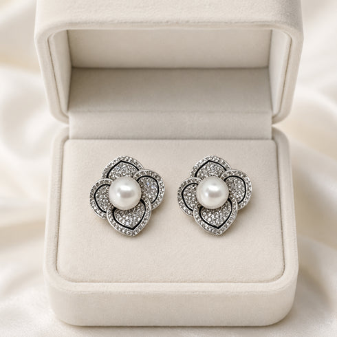 Earrings: pair of flower-shaped Akoya pearl studs with pave diamonds