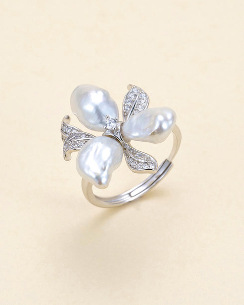 Ring featuring four Keshi silver-blue freshwater pearl petals forming a flower with diamond-accent leaves in silver.