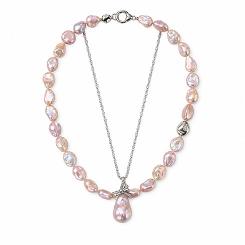 Keshi freshwater pearl set: iridescent pink-purple pearls on a layered necklace with floral pendant and teardrop pearl.