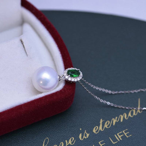 Necklace: 11-12mm freshwater pearl pendant with green gem halo on silver chain