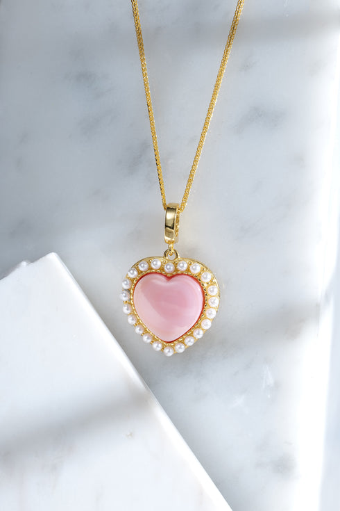 Gold vermeil heart pendant necklace with pink conch-shell center and pearl border on a rope chain.