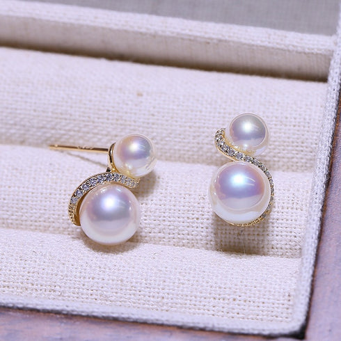 S Shape Double Pearl Earrings; gold-tone setting with two lustrous pearls and a diamond-studded curve.