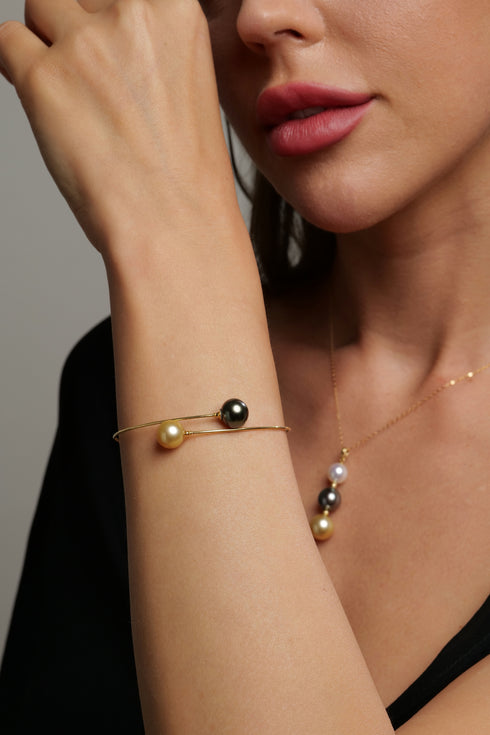 Bracelet: 11-12mm Golden South Sea & Tahitian pearls on an 18K gold open cuff.