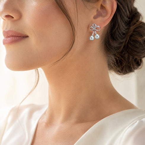 Earrings: celestial silver bow drop with dual 7–8mm Japanese Akoya blue pearls