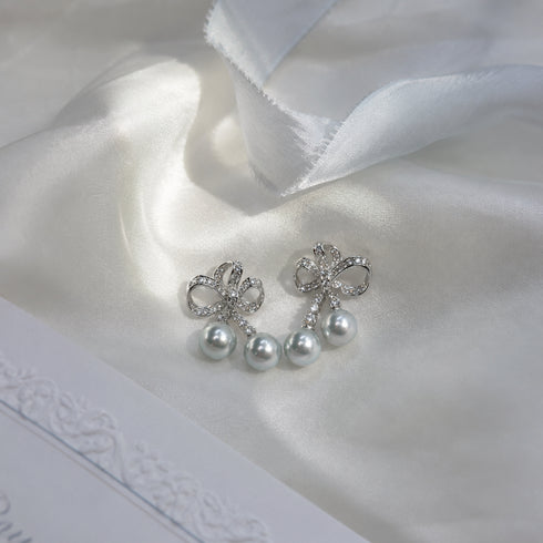 Pair of earrings by House Of Pearls: Celestial Bow Duo Drop with 7–8mm Japanese silver-blue Akoya pearls