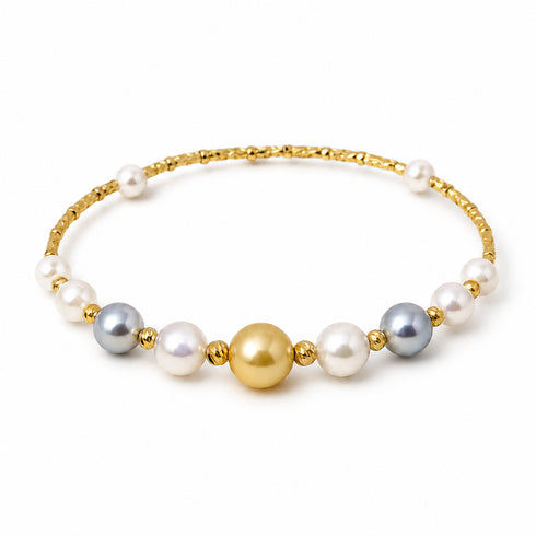 Bracelet with mixed Akoya and golden South Sea pearls on a gold-tone beaded band.