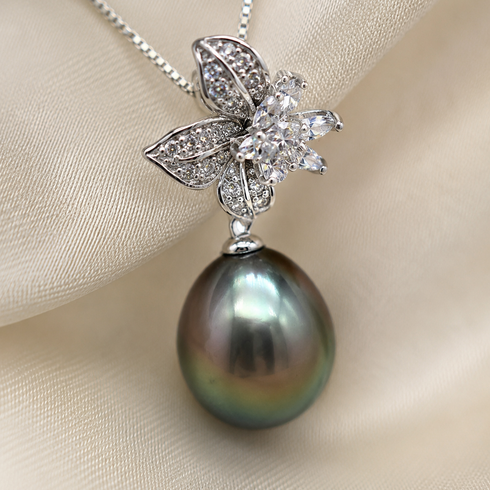 Necklace with sterling silver floral CZ pendant and 11–12mm Tahitian baroque pearl drop.