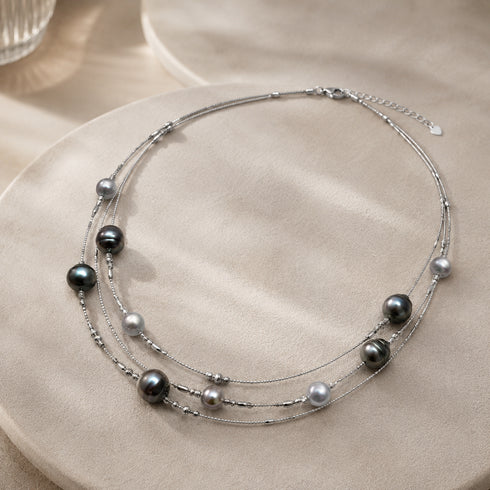 Necklace: Tahitian baroque pearl triple-layer by House Of Pearls TA; silver chains with dark gray 6–10mm pearls.