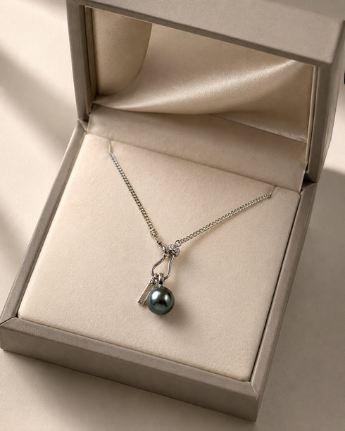 Necklace with 11–12mm Tahitian pearl lucky chain pendant on sterling silver chain in a beige jewelry box
