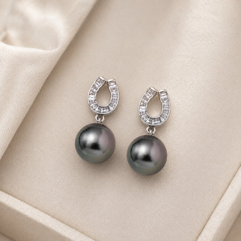 Earrings: House Of Pearls Tahitian South Sea Pearl Lunar Arch with diamond-encrusted arch and dark grey pearl drops.