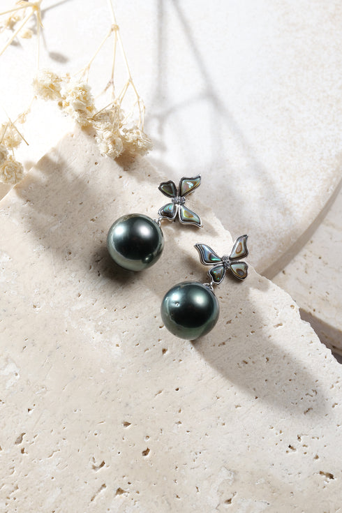 Earrings: Tahitian pearl halo hook earrings with dark green pearls and iridescent abalone flower charms