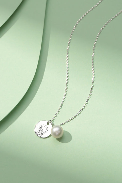 Necklace with Virgin Mary charm and white pearl pendant on a silver chain
