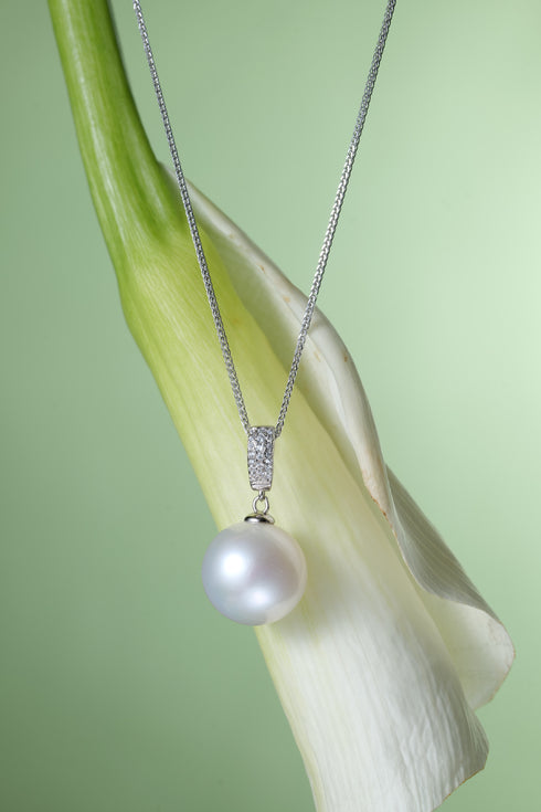 Freshwater pearl pendant necklace with a 13–14mm white pearl on a silver chain.
