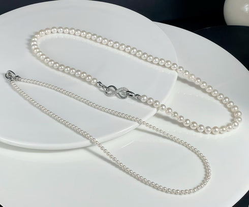 Versa Infinity Dual-Strand Freshwater Pearl Necklace with white pearls and a crystal-studded silver infinity clasp