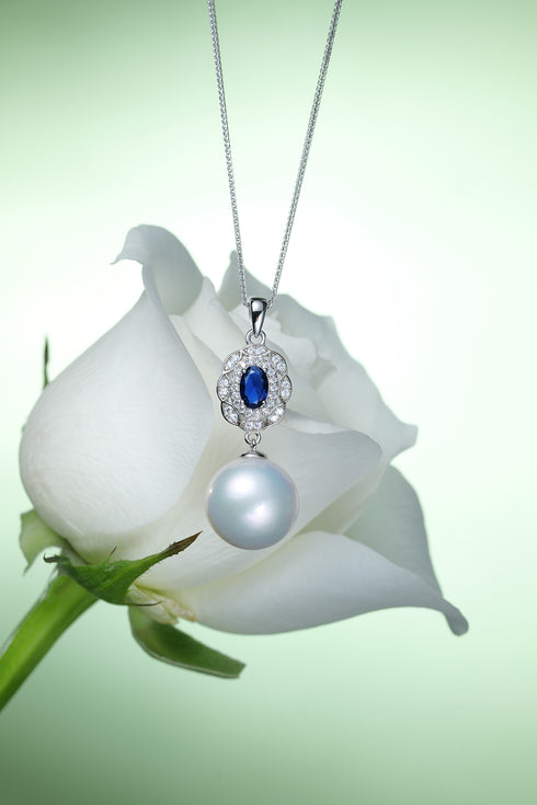 13-14mm freshwater pearl pendant necklace with royal blue center stone, diamond halo, pearl drop on silver chain.